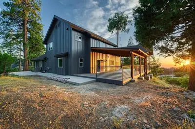 a black house with a gambrel roof at Sunset Retreat AC, Big Views & Dream Deck in Shaver Lake