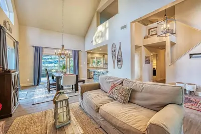 a living room with a couch and a dining room at Sunset Retreat AC, Big Views & Dream Deck in Shaver Lake