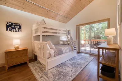 a bedroom with a bunk bed and a desk at Knotty and Nice - 4BR w Private Hot Tub, Close to Lake in Tahoe Vista