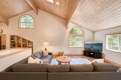 a living room with a couch and a table at Knotty and Nice - 4BR w Private Hot Tub, Close to Lake in Tahoe Vista