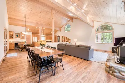a dining room and living room with a table and chairs at Knotty and Nice - 4BR w Private Hot Tub, Close to Lake in Tahoe Vista