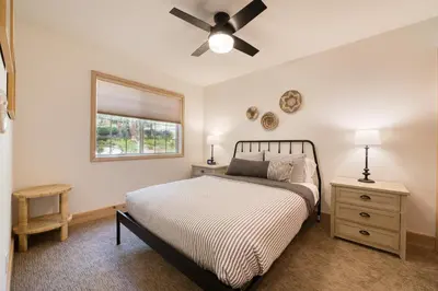 a bedroom with a bed and a ceiling fan at Knotty and Nice - 4BR w Private Hot Tub, Close to Lake in Tahoe Vista