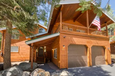 a log home with a balcony and a garage at Knotty and Nice - 4BR w Private Hot Tub, Close to Lake in Tahoe Vista
