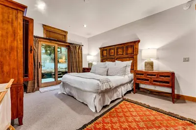 a bedroom with a bed and a dresser and a window at Northstar Ski-In Ski-Out with Valley Views in Ponderosa Fairway Estates