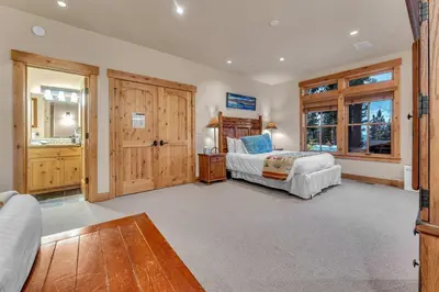 a bedroom with a bed and a desk in a room at Northstar Ski-In Ski-Out with Valley Views in Ponderosa Fairway Estates