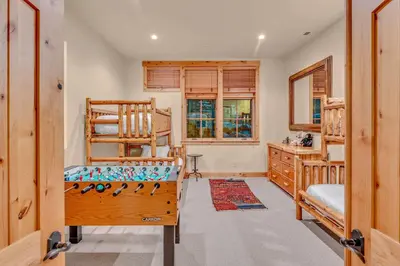 a bedroom with two bunk beds and a window at Northstar Ski-In Ski-Out with Valley Views in Ponderosa Fairway Estates