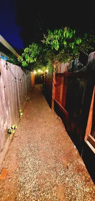 a walkway with a fence and plants on it at Secret Oasis in Sacramento! in Sacramento