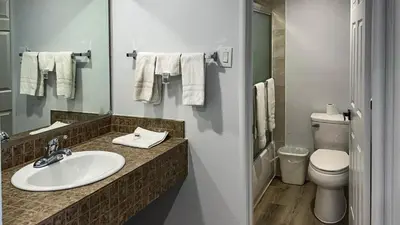 a bathroom with a sink and a toilet and a mirror at Motel 6 Selma, CA in Selma