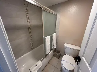 a small bathroom with a toilet and a shower at Motel 6 Selma, CA in Selma