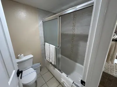 a bathroom with a toilet and a glass shower at Motel 6 Selma, CA in Selma