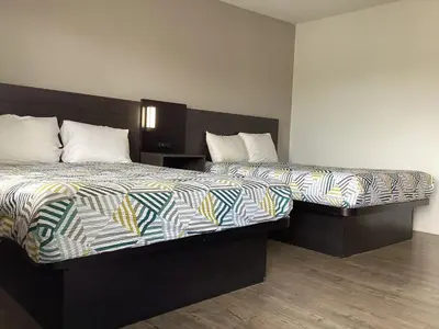 two beds sitting next to each other in a room at Motel 6 Selma, CA in Selma