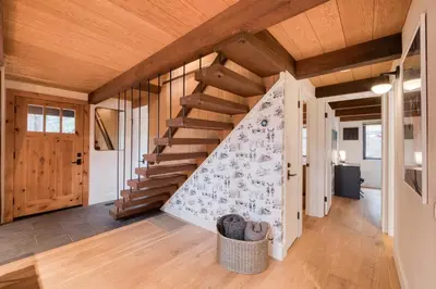 a staircase in a house with wooden ceilings at A-Frame of Mind in Tahoe Donner - Pet-Friendly 2 BR 1 BA with Pool Table in Truckee