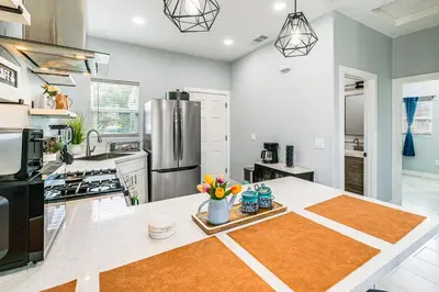 a kitchen with a table with flowers on it at Small-Town Charm and Patio Dining Home in Madera! in Madera