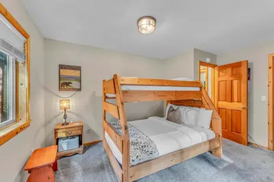a bedroom with two bunk beds and a desk at Tahoe Retreat with Scenic Views and Spacious Deck in Tahoe Vista