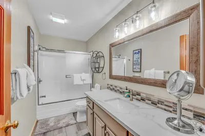 a bathroom with a sink and a toilet and a mirror at Tahoe Retreat with Scenic Views and Spacious Deck in Tahoe Vista