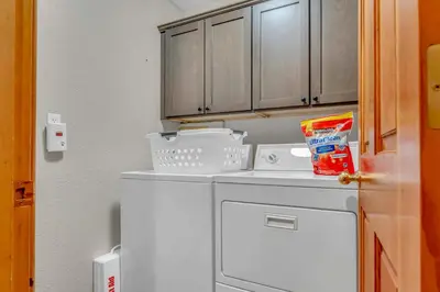 a small kitchen with a white washer at Tahoe Retreat with Scenic Views and Spacious Deck in Tahoe Vista