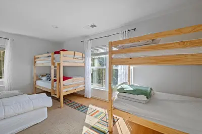 a room with two bunk beds and a couch at Zen Whisper in the Woods in Groveland