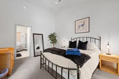 a bedroom with a large bed and a mirror at Zen Whisper in the Woods in Groveland
