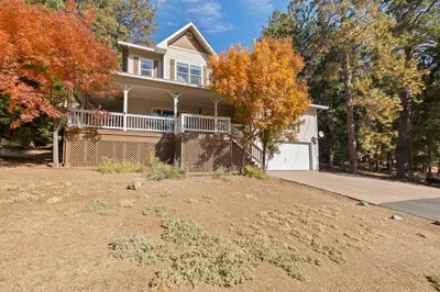 a house with a large yard in front of it at Zen Whisper in the Woods in Groveland