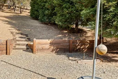 a wooden fence with a ball hanging from a pole at Zen Whisper in the Woods in Groveland