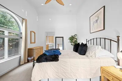 a bedroom with a bed with pillows on it at Zen Whisper in the Woods in Groveland
