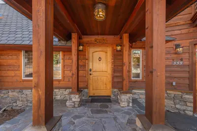 a wooden front door of a log cabin at Home for 10 Private Hot-Tub Close to Ski Private Beach Access w Double Decker pier Book on Mobile for Promo Price in Carnelian Bay
