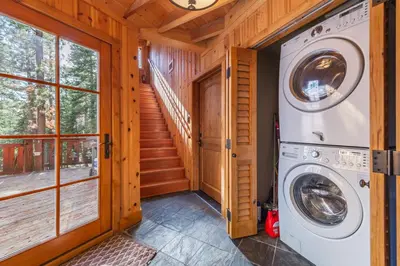 a laundry room with a washer and dryer in a cabin at Home for 10 Private Hot-Tub Close to Ski Private Beach Access w Double Decker pier Book on Mobile for Promo Price in Carnelian Bay