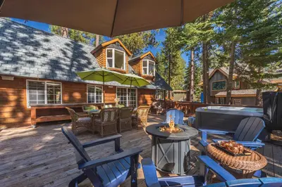 a deck with chairs and a fire pit on a house at Home for 10 Private Hot-Tub Close to Ski Private Beach Access w Double Decker pier Book on Mobile for Promo Price in Carnelian Bay