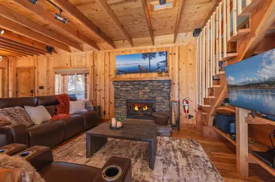 a living room with a couch and a fireplace at Home for 10 Private Hot-Tub Close to Ski Private Beach Access w Double Decker pier Book on Mobile for Promo Price in Carnelian Bay