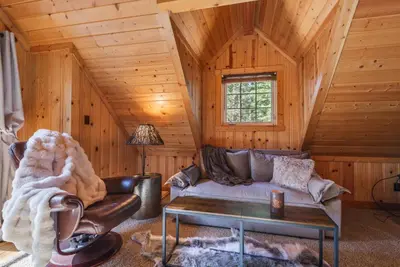 a living room with a couch and a table in a cabin at Home for 10 Private Hot-Tub Close to Ski Private Beach Access w Double Decker pier Book on Mobile for Promo Price in Carnelian Bay
