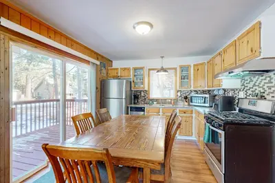 a kitchen with a wooden table and chairs and a stove at Lipan Lodge in South Lake Tahoe