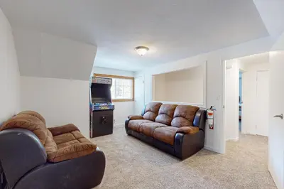 a living room with two leather couches and a tv at Lipan Lodge in South Lake Tahoe