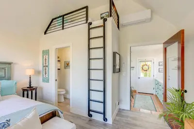 a room with a bed and a loft bed with a ladder at Steps to Sutter Creek Chic Wine Country Cottage in Sutter Creek