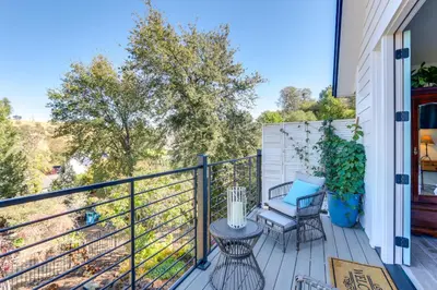 a balcony with a table and two chairs on it at Steps to Sutter Creek Chic Wine Country Cottage in Sutter Creek