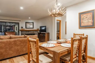 a dining room with a table and a couch at Summit #269 - 2 Bedrm 2 Bathrm Condo - Walk To Eagle Lodge Lifts in Mammoth Lakes