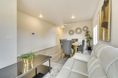 a living room with a couch and a table at Chowchilla Home with Private Patio! in Chowchilla
