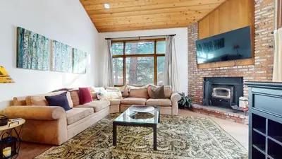 a living room with a couch and a fireplace at Woodlands #40 condo in Mammoth Lakes