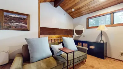 a living room with a couch and a table at Woodlands #40 condo in Mammoth Lakes