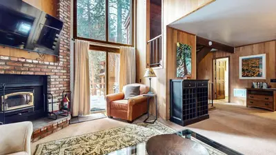 a living room with a chair and a fireplace at Woodlands #40 condo in Mammoth Lakes