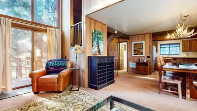 a living room with a chair and a desk at Woodlands #40 condo in Mammoth Lakes