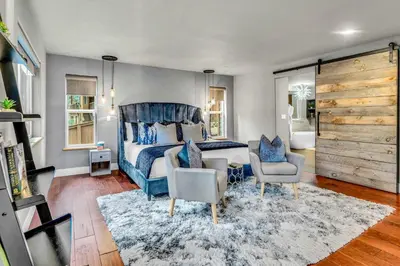 a bedroom with a blue bed and two chairs at Upscale Incline Village Home with Hot Tub & Sauna in Incline Village