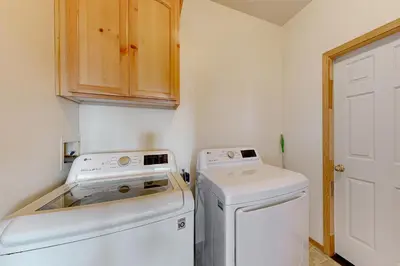 a small kitchen with a washer and dryer at Skislope Serenity in Truckee