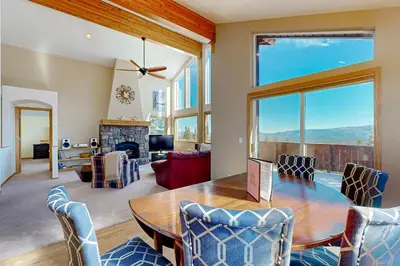 a dining room with a table and chairs and a fireplace at Skislope Serenity in Truckee