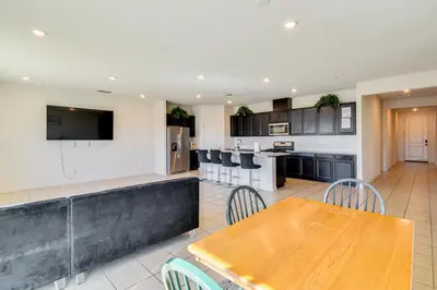 a kitchen with a wooden table and a kitchen with a counter at WFH-Friendly Getaway with Yard in Manteca! in Manteca
