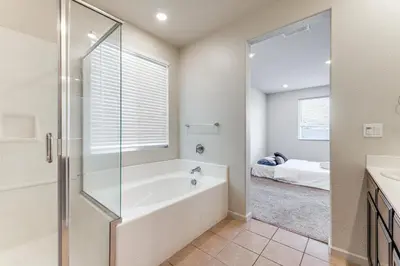 a bathroom with a shower and a tub and a sink at WFH-Friendly Getaway with Yard in Manteca! in Manteca