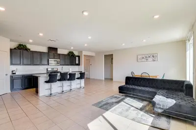 a living room with a couch and a kitchen at WFH-Friendly Getaway with Yard in Manteca! in Manteca
