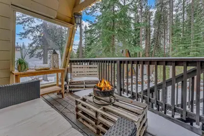 a patio with a fire pit on a porch at White Fir Chalet Dog Friendly Cabin in the Woods in Soda Springs
