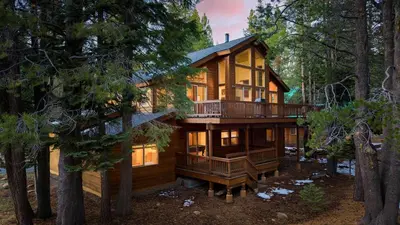 a log home in the woods with a deck at Hansel by AvantStay Pool Table 5mins to Skiing in Truckee