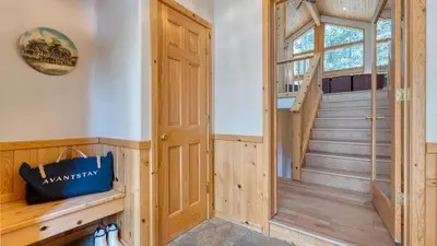 a room with a wooden door and a staircase at Hansel by AvantStay Pool Table 5mins to Skiing in Truckee