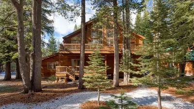 a log cabin in the woods with a deck at Hansel by AvantStay Pool Table 5mins to Skiing in Truckee